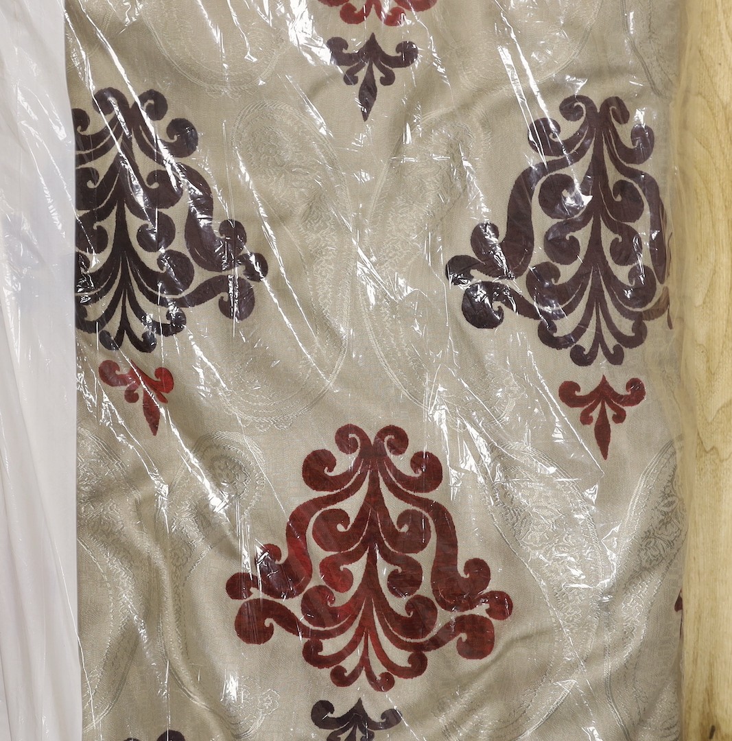 A large pair of silver brocaded curtains, with a woven paisley tear drop motif and large all over plum cut velvet Fleur-de-lis motifs, together with matching corded and tasselled tie backs.